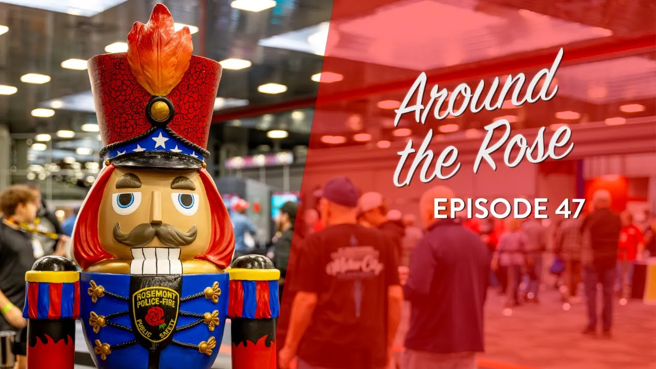 A decorative nutcracker figure in a Rosemont Police and Fire uniform stands indoors; people gather in the background. Text reads Around the Rose Episode 47.