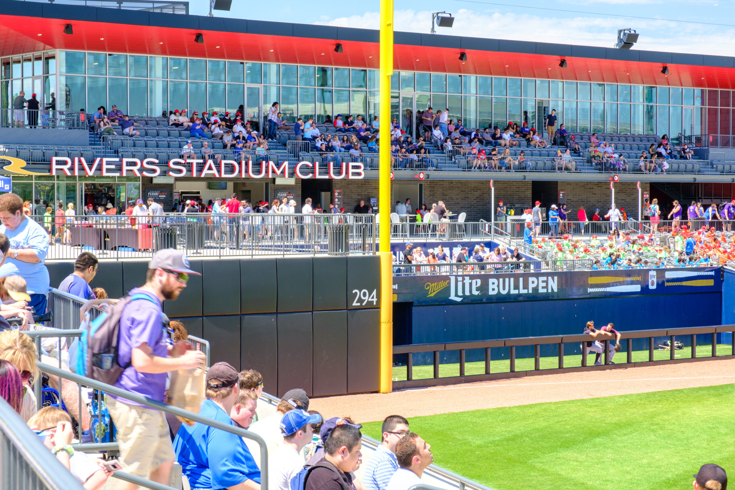 Fans in the stadium seating area and Rivers Stadium Club at a baseball game.
